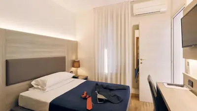 Letto o letti in una camera di Hotel Roberta