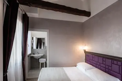 Letto o letti in una camera di Hotel Paganelli