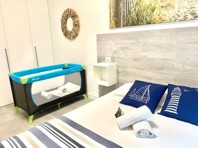 Letto o letti in una camera di Civico 148- Lido di Jesolo - Per Famiglie