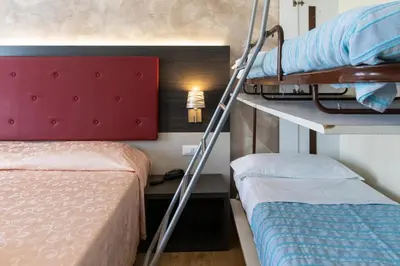 Letto o letti in una camera di Hotel Verdi