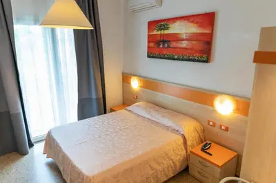 Letto o letti in una camera di Hotel Verdi