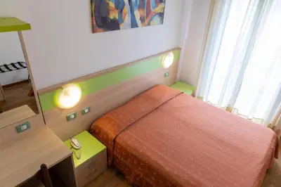 Letto o letti in una camera di Hotel Verdi