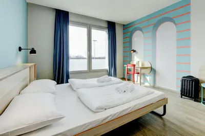 Letto o letti in una camera di MEININGER Venezia Mestre
