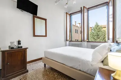 Letto o letti in una camera di Residenza Centopietre - Dorsoduro by Wonderful Italy
