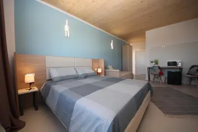 Letto o letti in una camera di Ohana Holiday Rooms