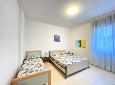 Letto o letti in una camera di Palazzo Masotto - Carraro Immobiliare - Family Apartments