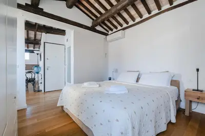 Letto o letti in una camera di San Marco vista sui tetti veneziani Apartment