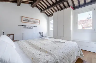 Letto o letti in una camera di San Marco vista sui tetti veneziani Apartment